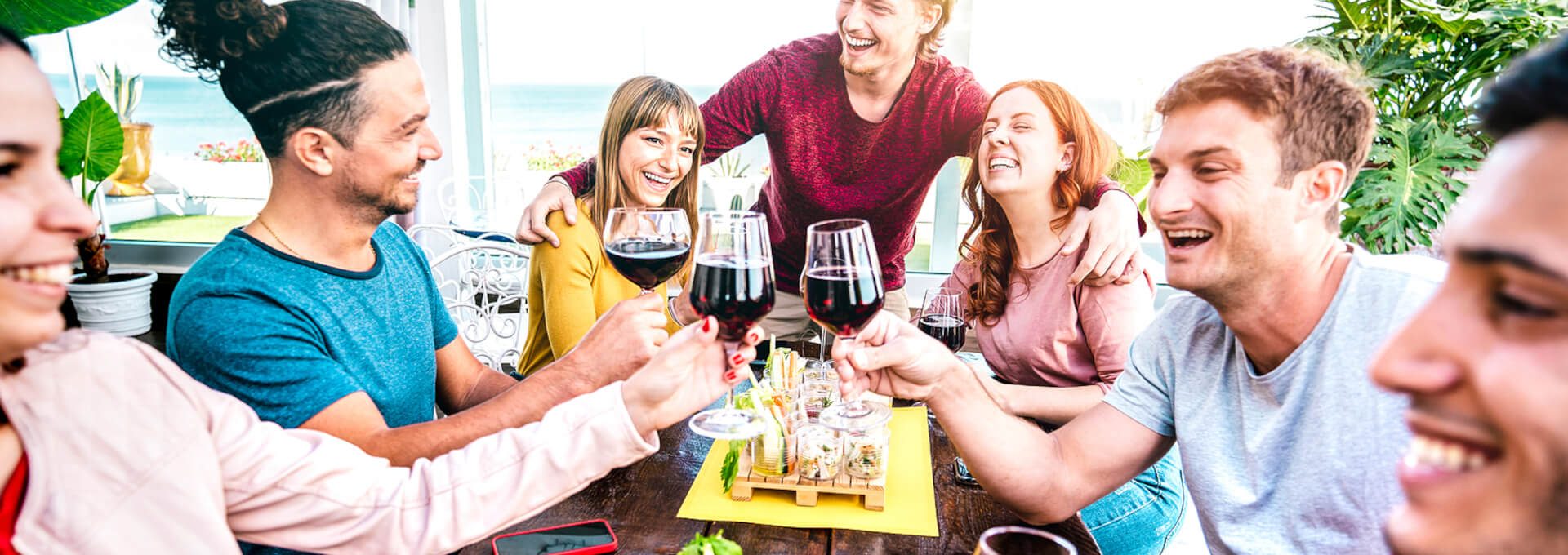group of friends toasting wine at a restaurant at The  Apiary