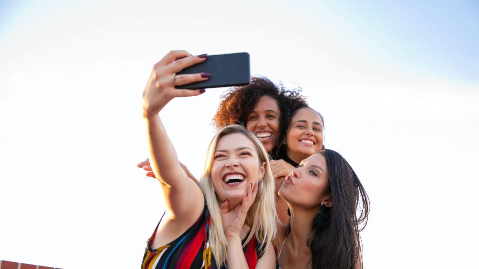 a group of women taking a selfie with their cell phone at The  Apiary